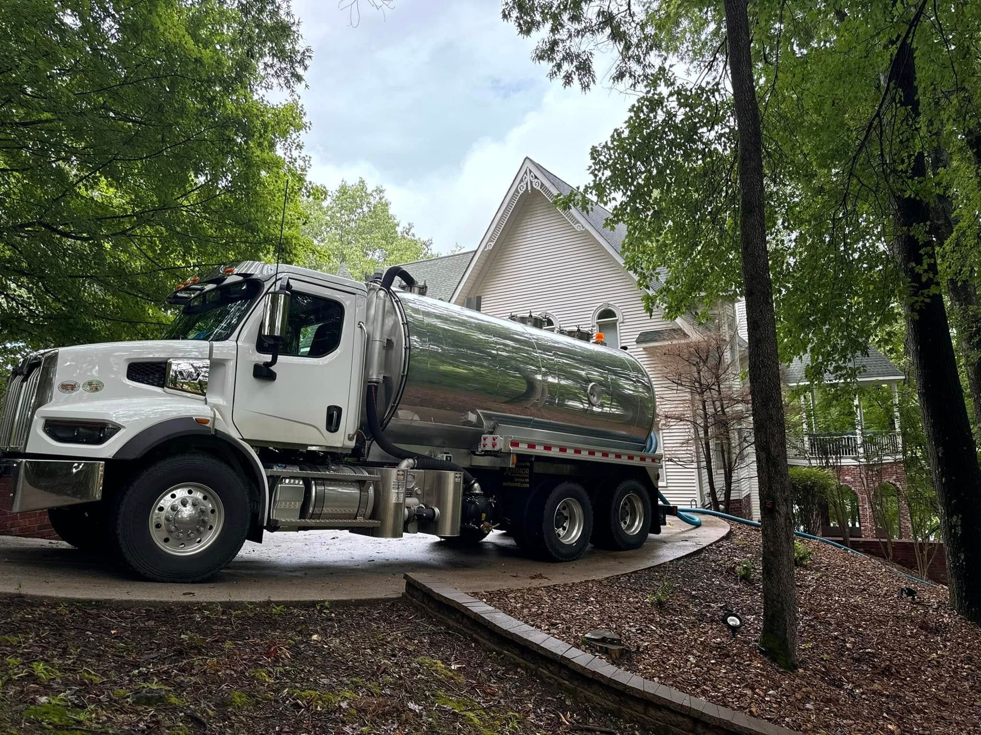 A large white truck is parked in front of a house.