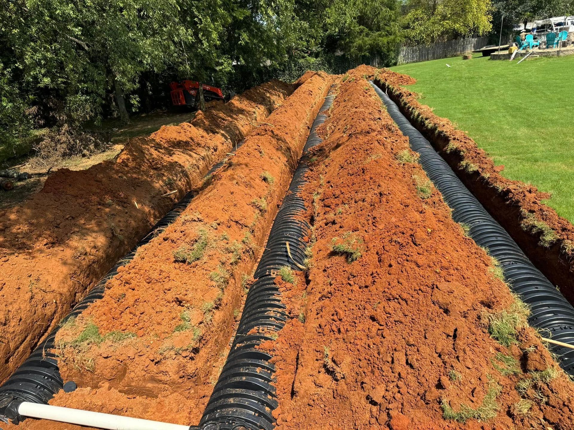 A septic system is being installed in a yard.
