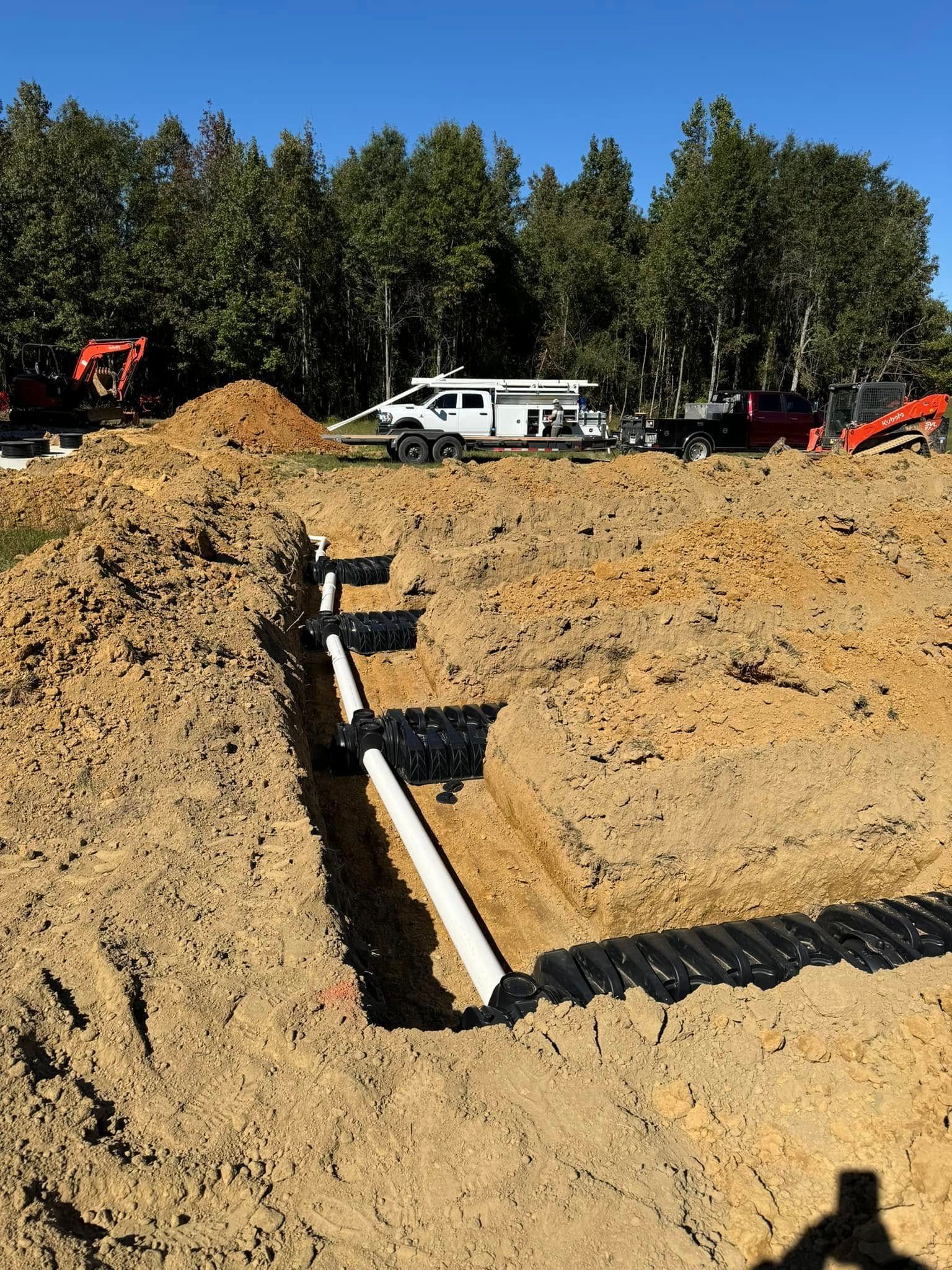A white truck is parked in the middle of a dirt field.
