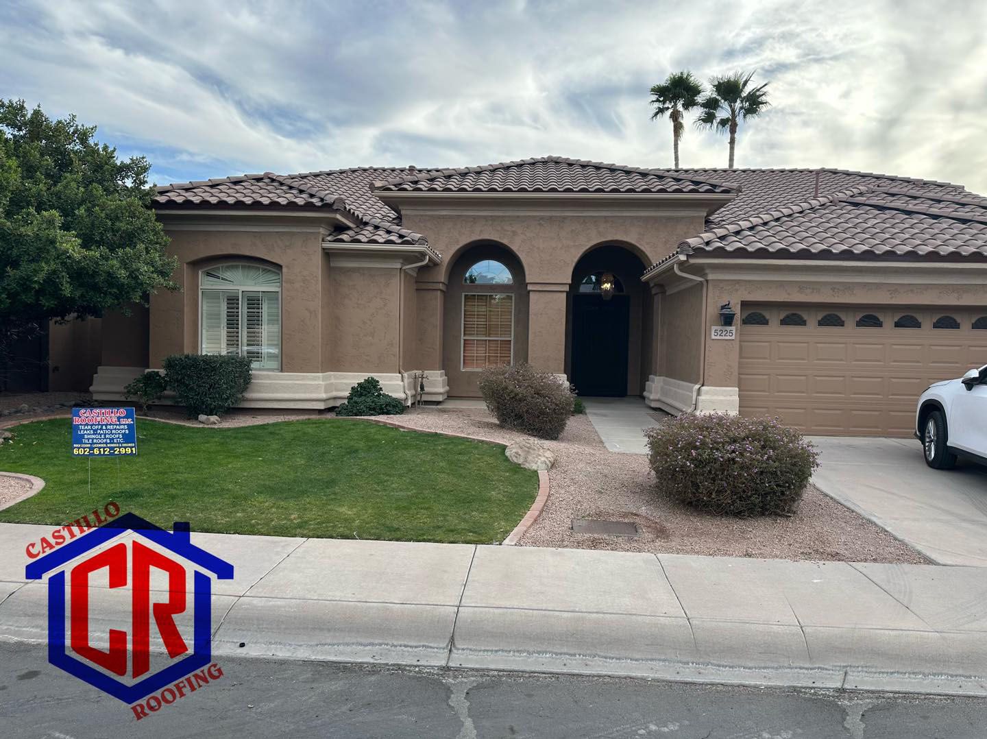 A large house with a car parked in front of it