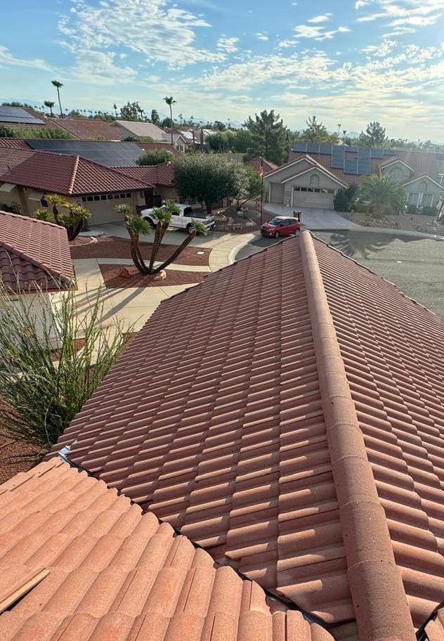 A red car is parked on the roof of a house.
