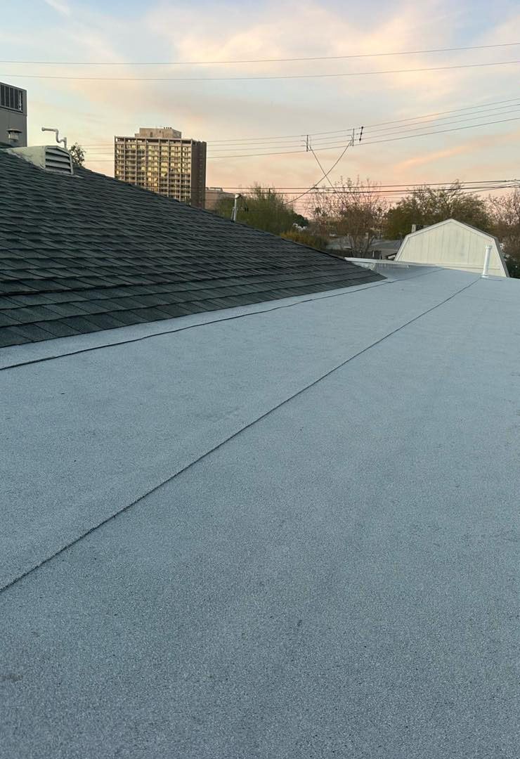 A close up of a roof with a city in the background.