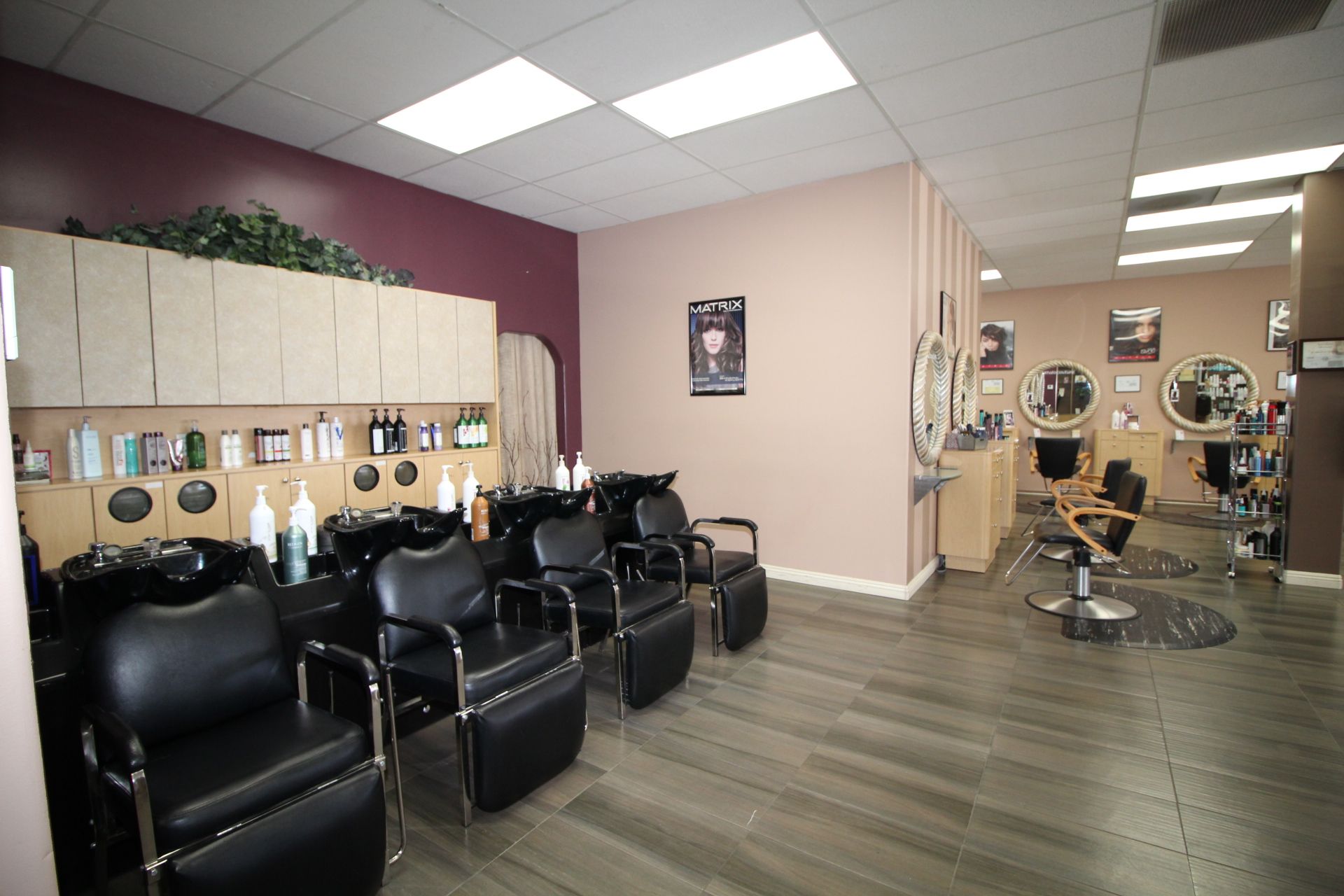 A hair salon with a lot of chairs and sinks.