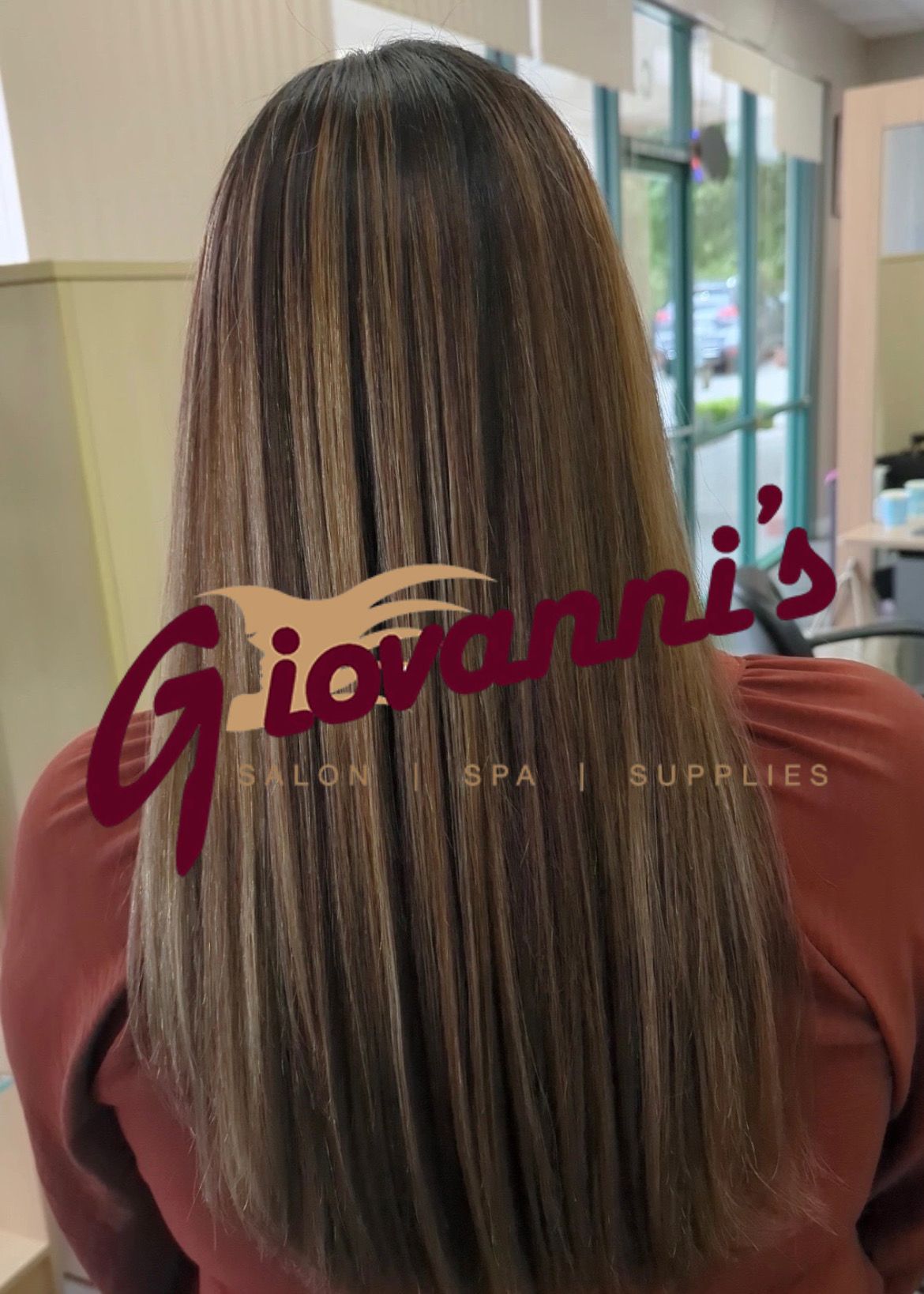 A woman with long hair is sitting in a salon.