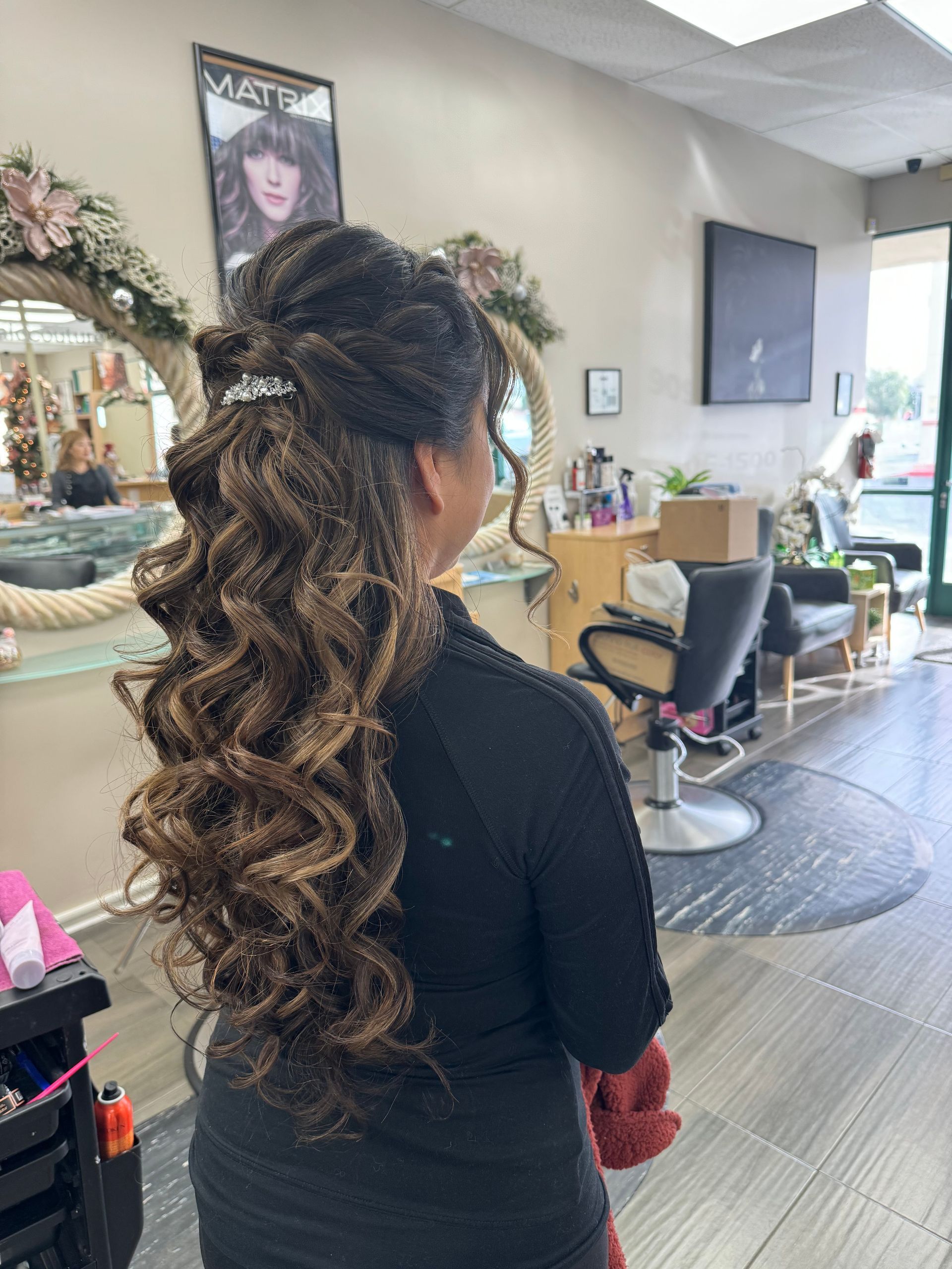 A woman is getting her hair done in a salon.