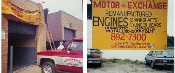 A red truck in front of a motor exchange shop. A person on a ladder and a yellow sign.