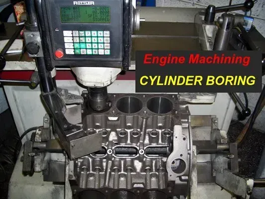 Engine block on a boring machine, cylinders being machined with digital readout.