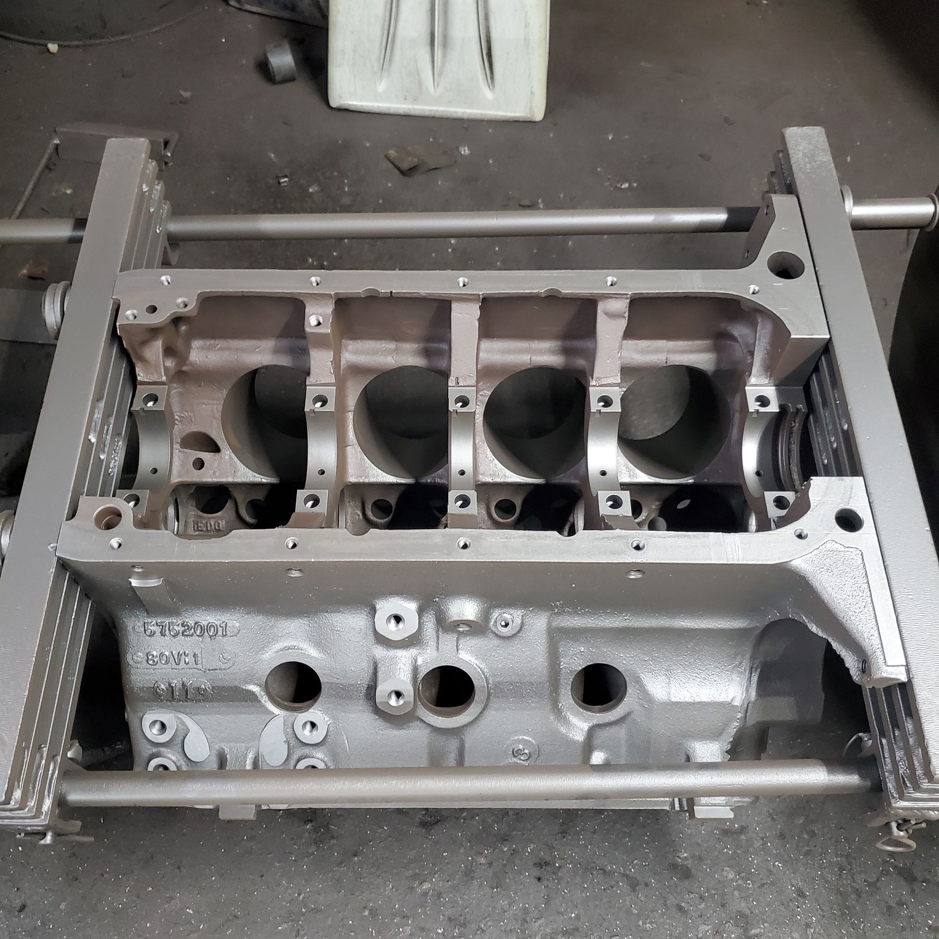 Engine block supported by a grey frame.