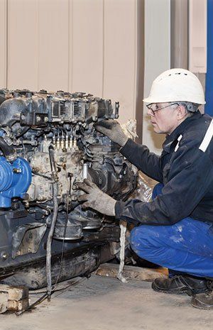 Technician repairing the engine of the truck