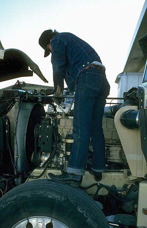 Technician putting fluid on the engine
