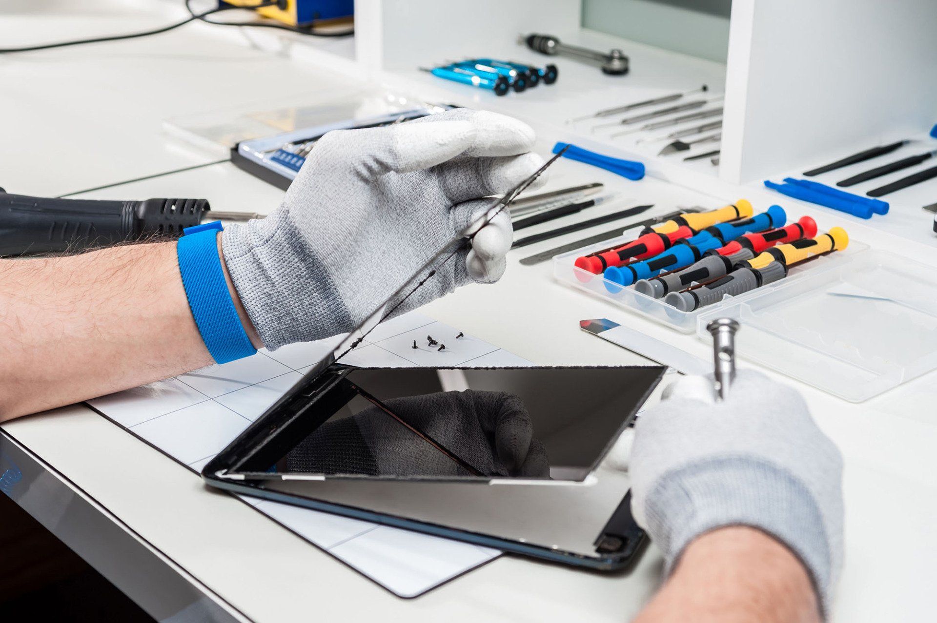 Technician replacing a tablet screen