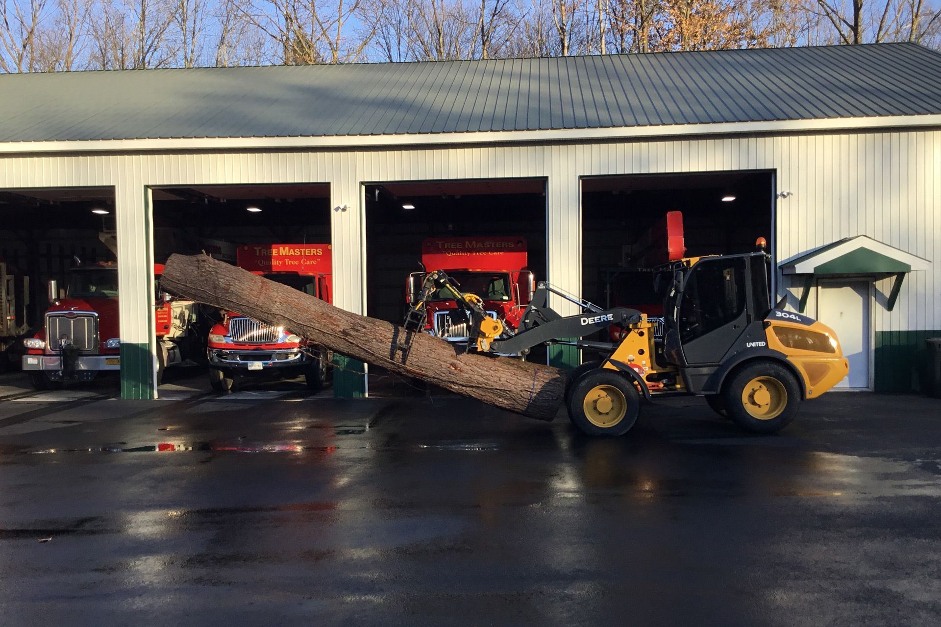 A bulldozer is carrying a large log