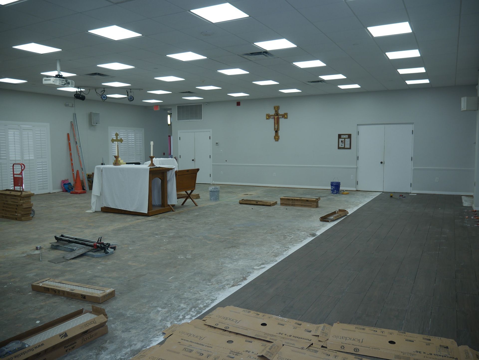 An empty church with a cross on the wall