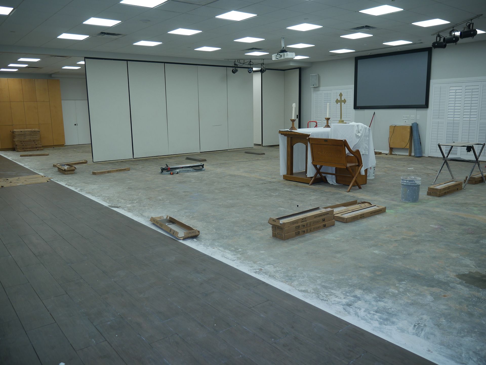 A large empty room with a wooden altar in the middle