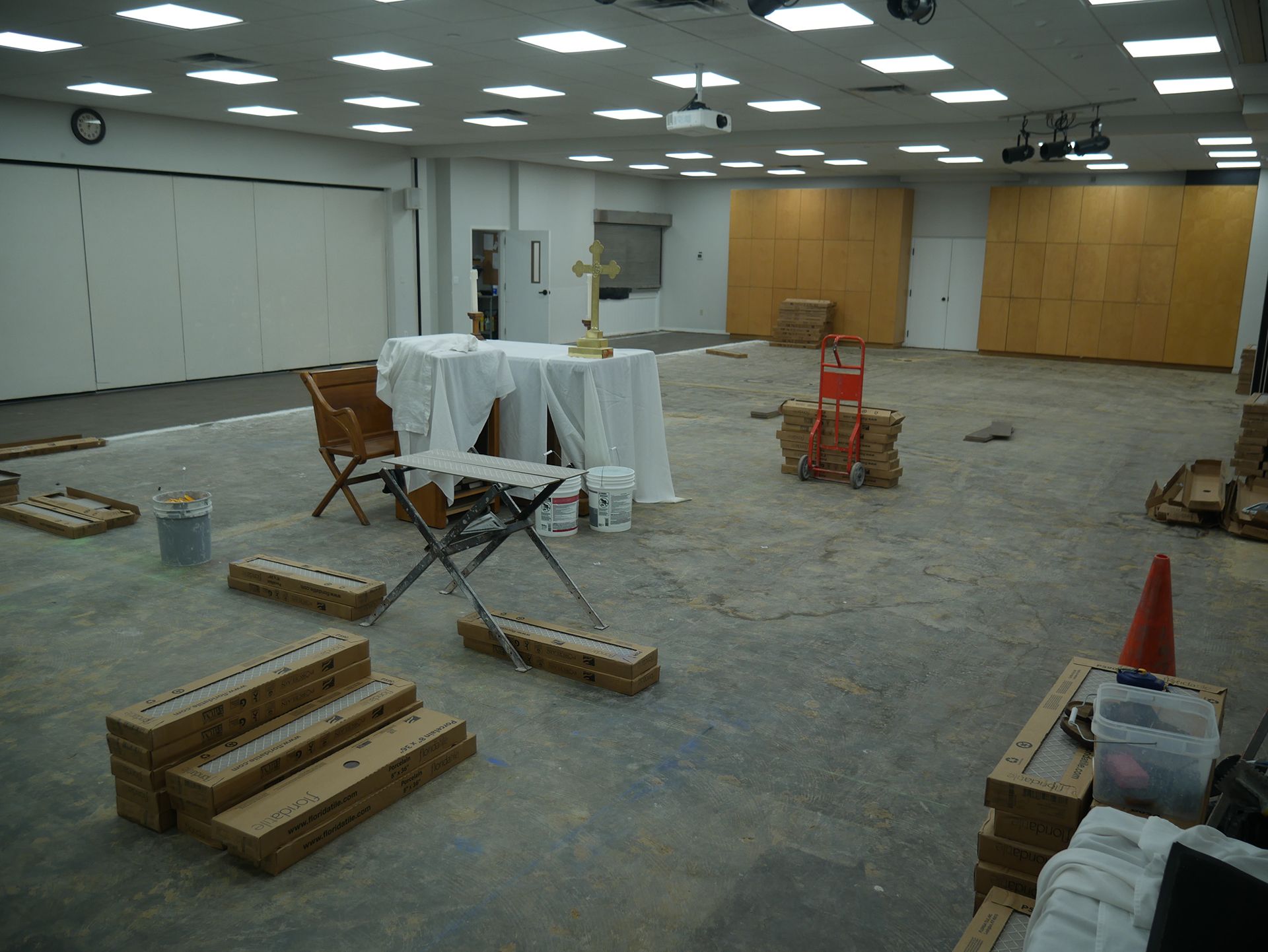 A large room with a table and chairs in it