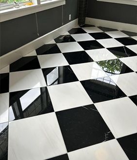 A black and white checkered floor in a room with a window.