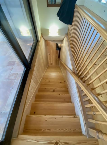 A wooden staircase leading up to the second floor of a house