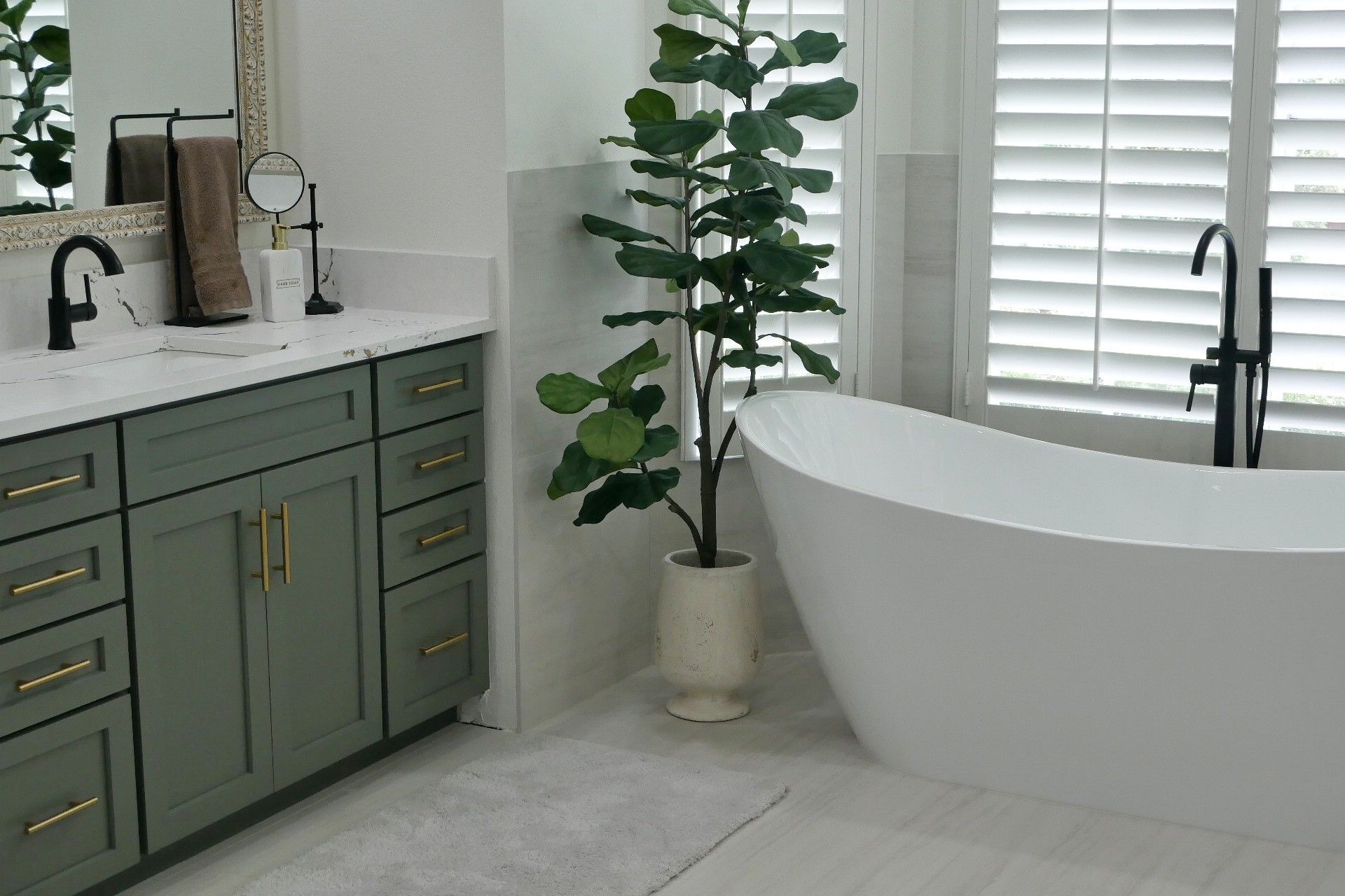 A bathroom with green cabinets