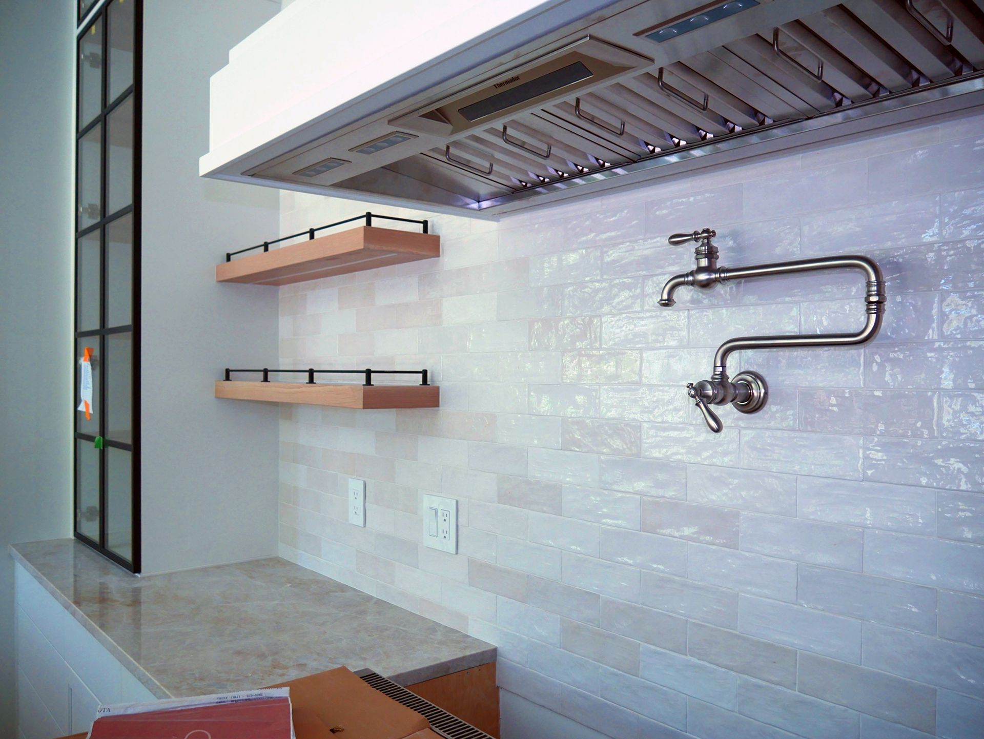 A kitchen with a sink and a faucet on the wall