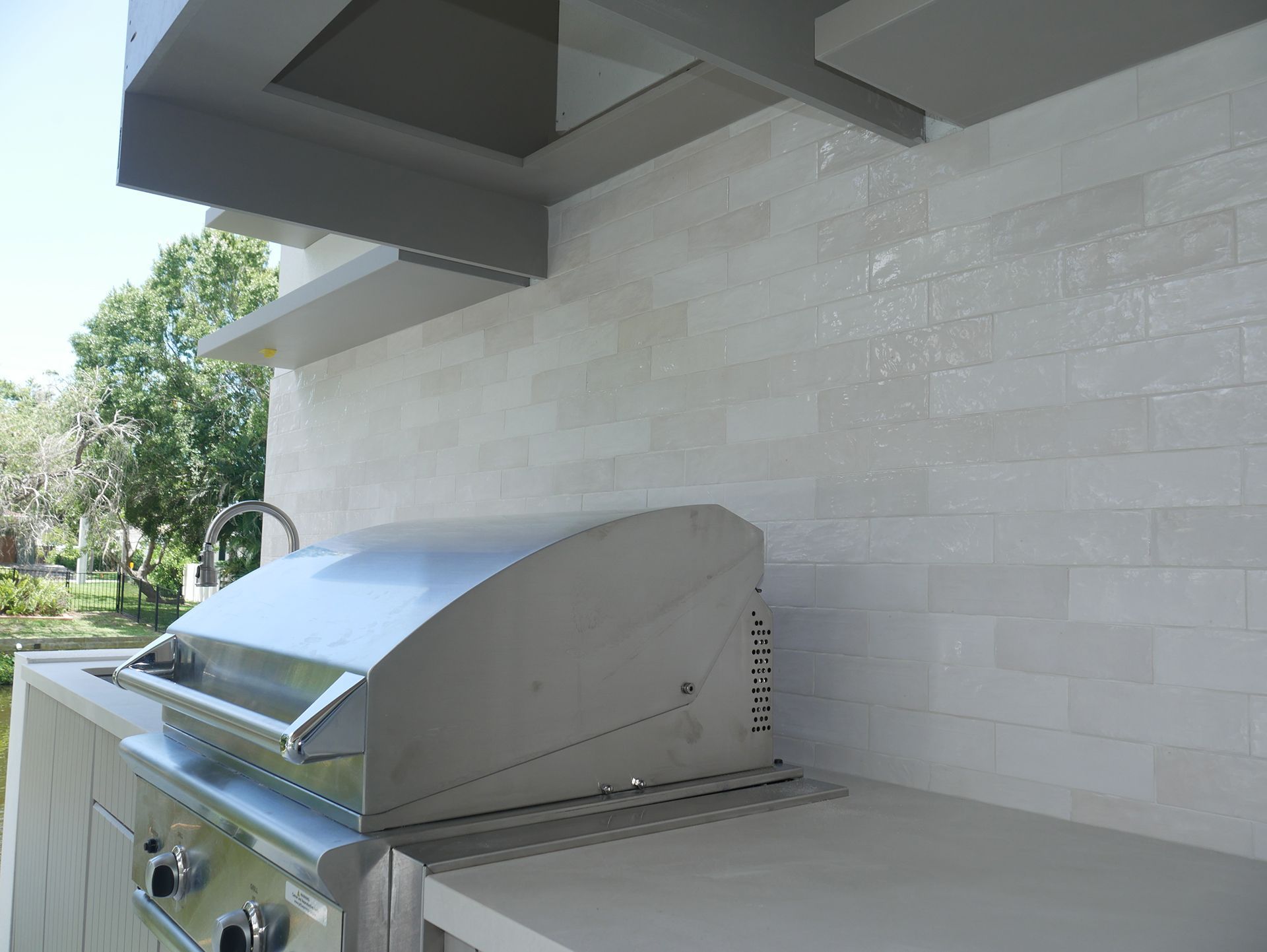 A stainless steel grill is sitting on top of a counter