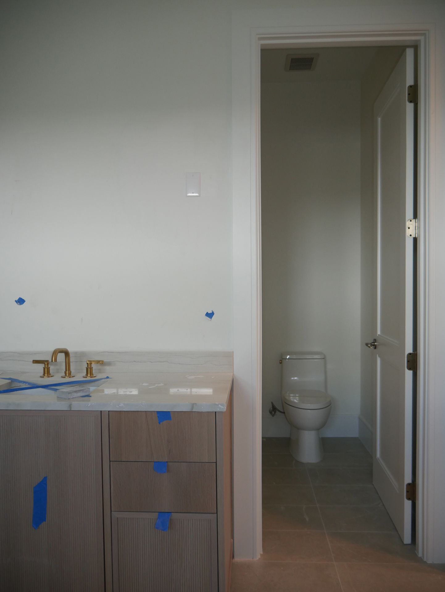 A bathroom with a toilet and a sink under construction