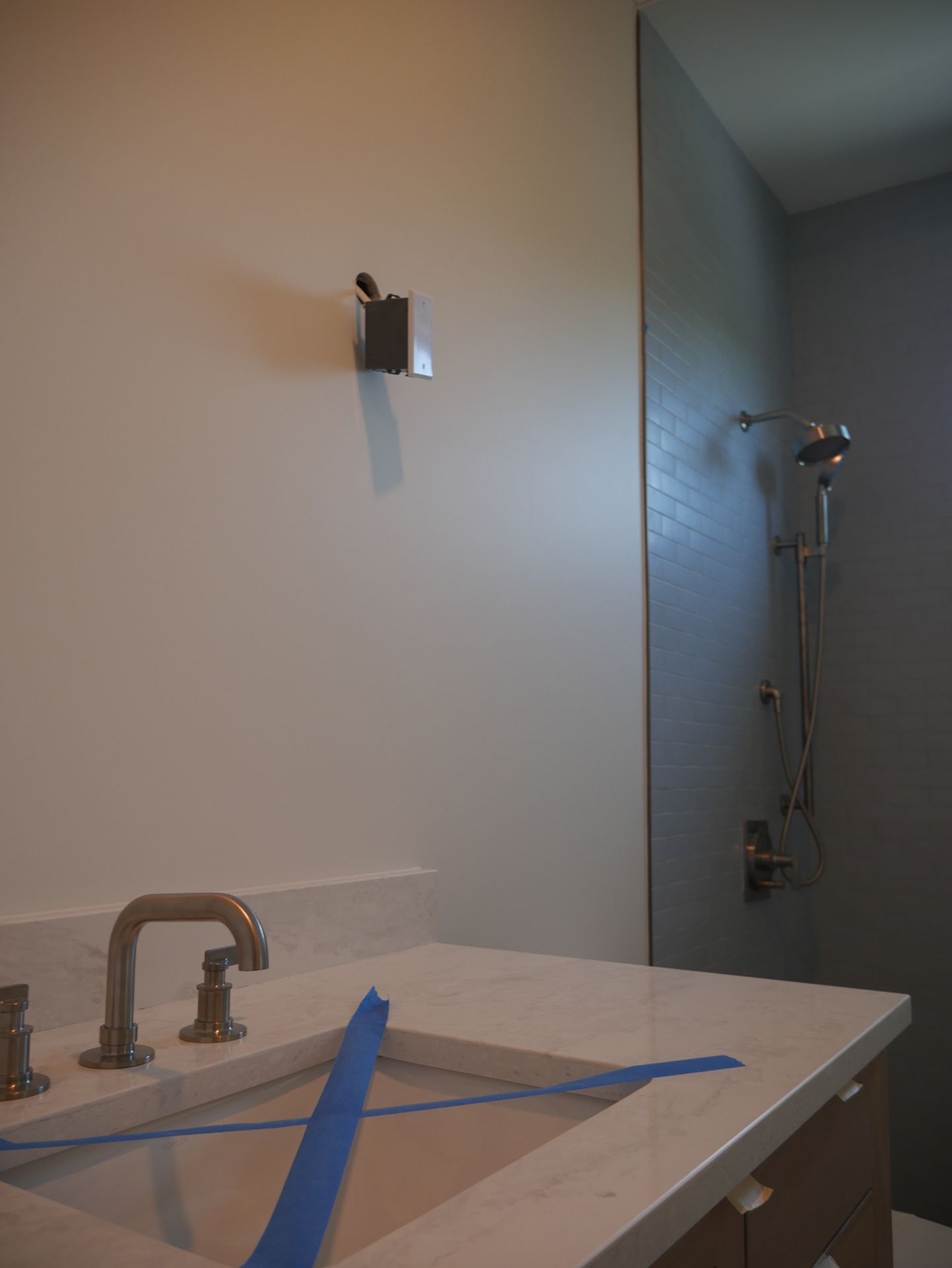A bathroom with a sink and shower 