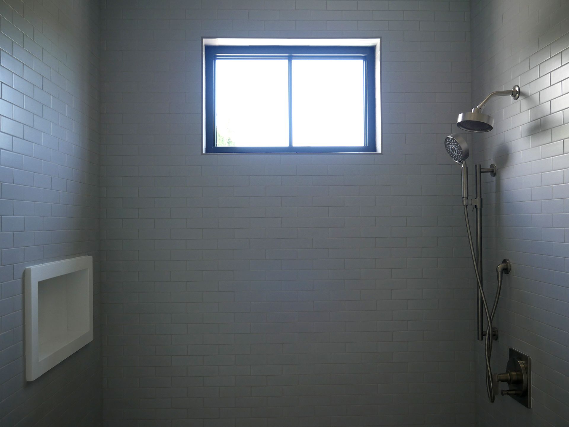 Shower with gray wall tiles