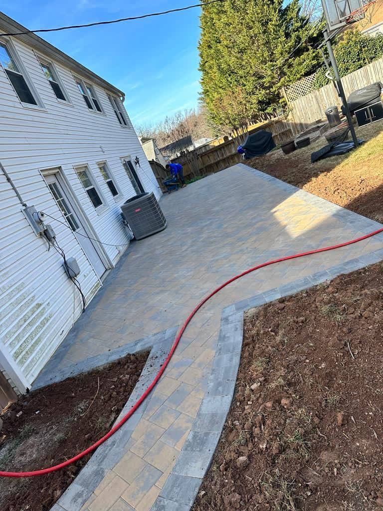 A hose is connected to a patio in front of a house.