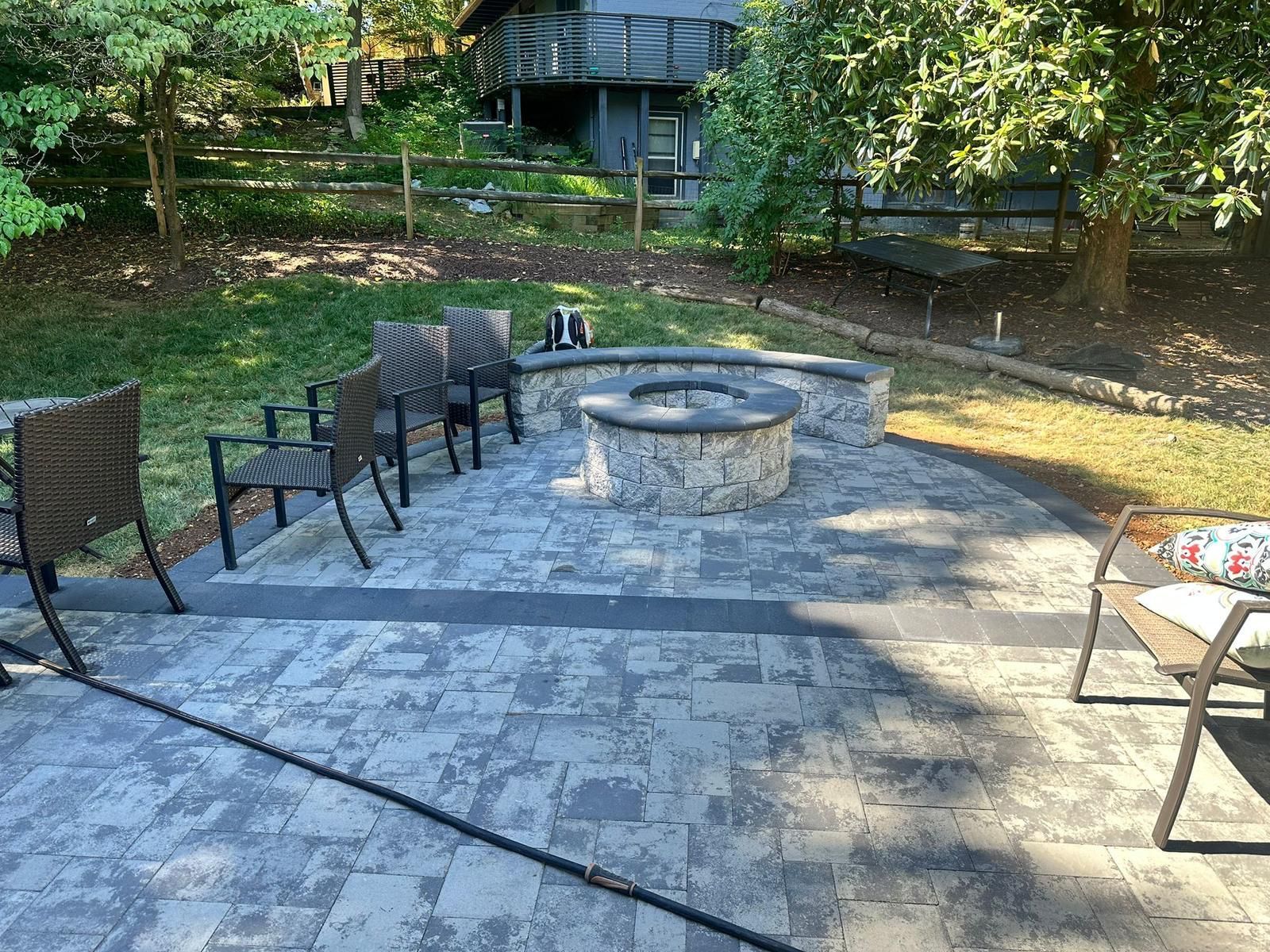There is a fire pit in the middle of the patio.