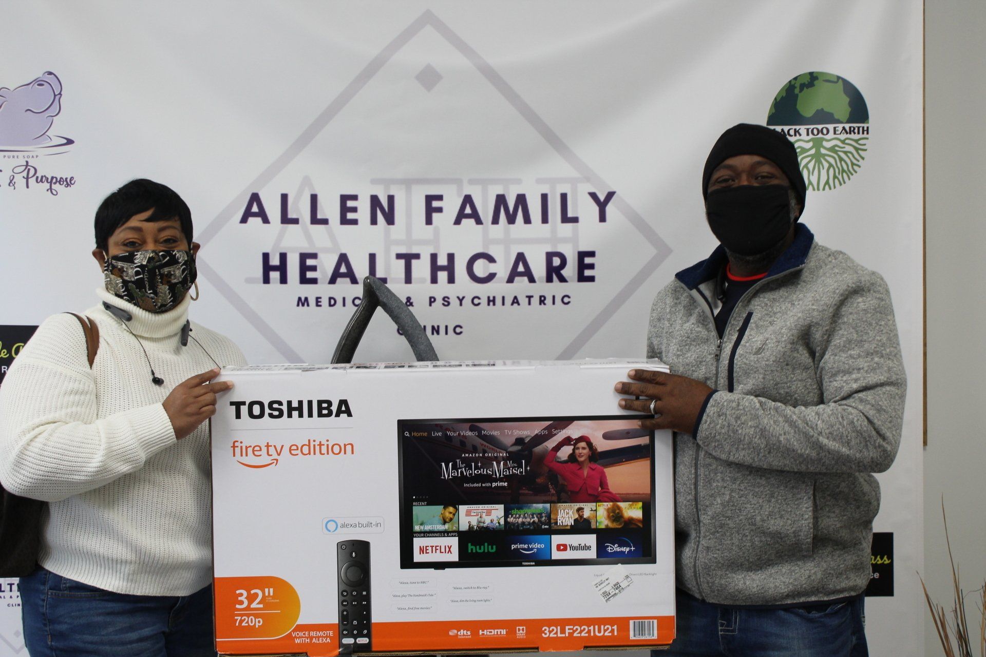 Man and woman holding a tv