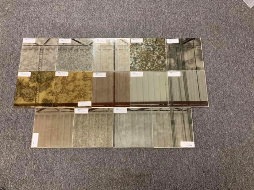A display of different types of mirrors on a carpeted floor