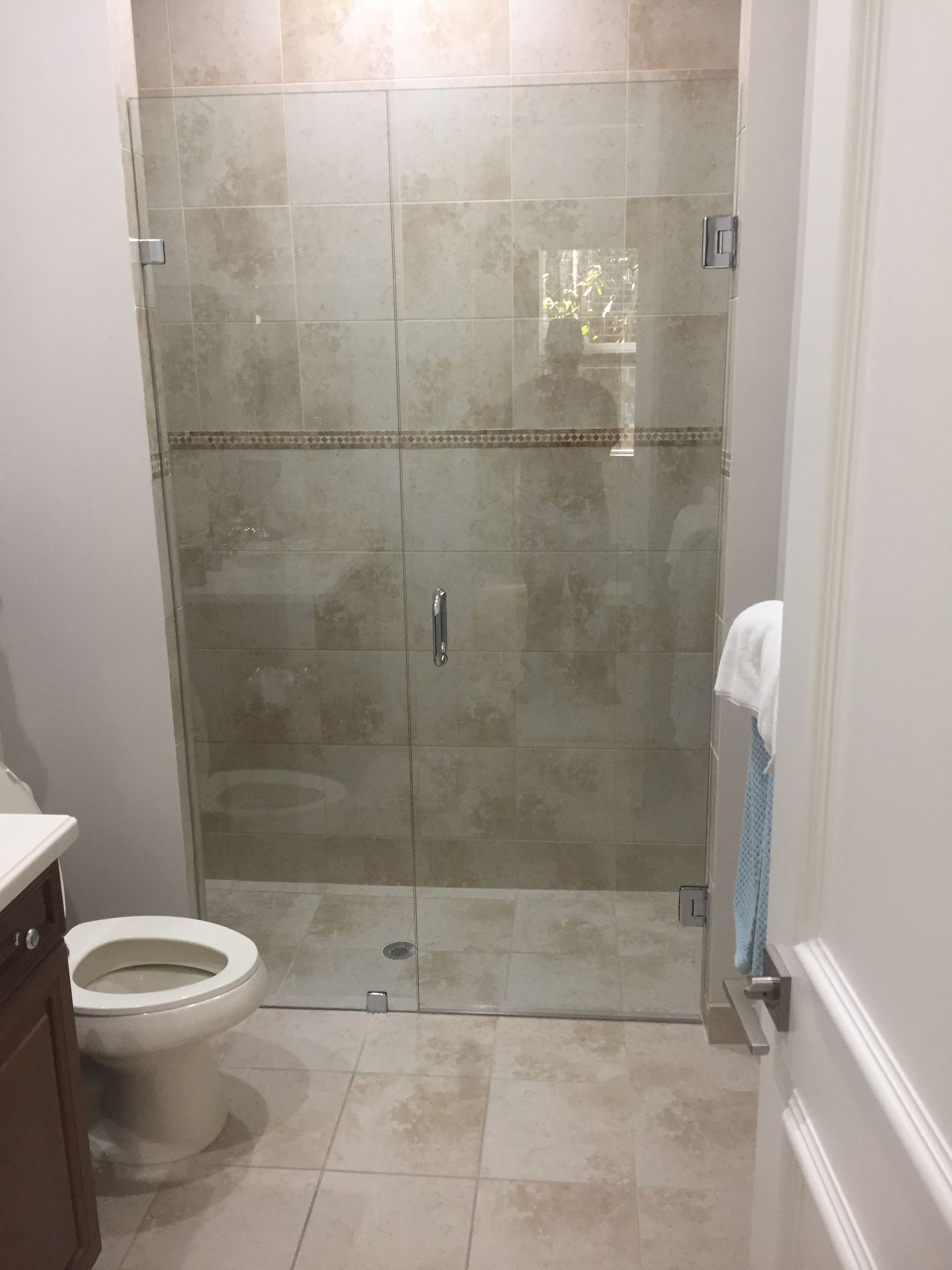 A bathroom with a toilet, sink, and walk-in shower.