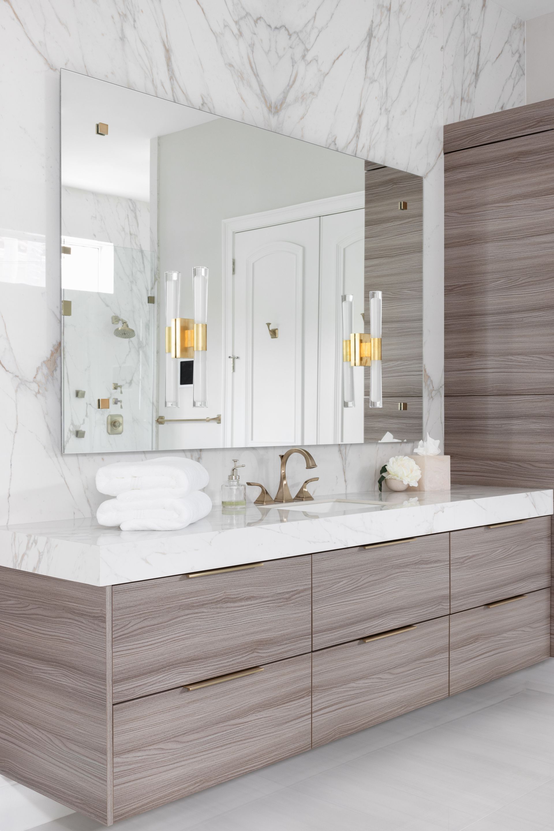 A bathroom with a large mirror and a sink.