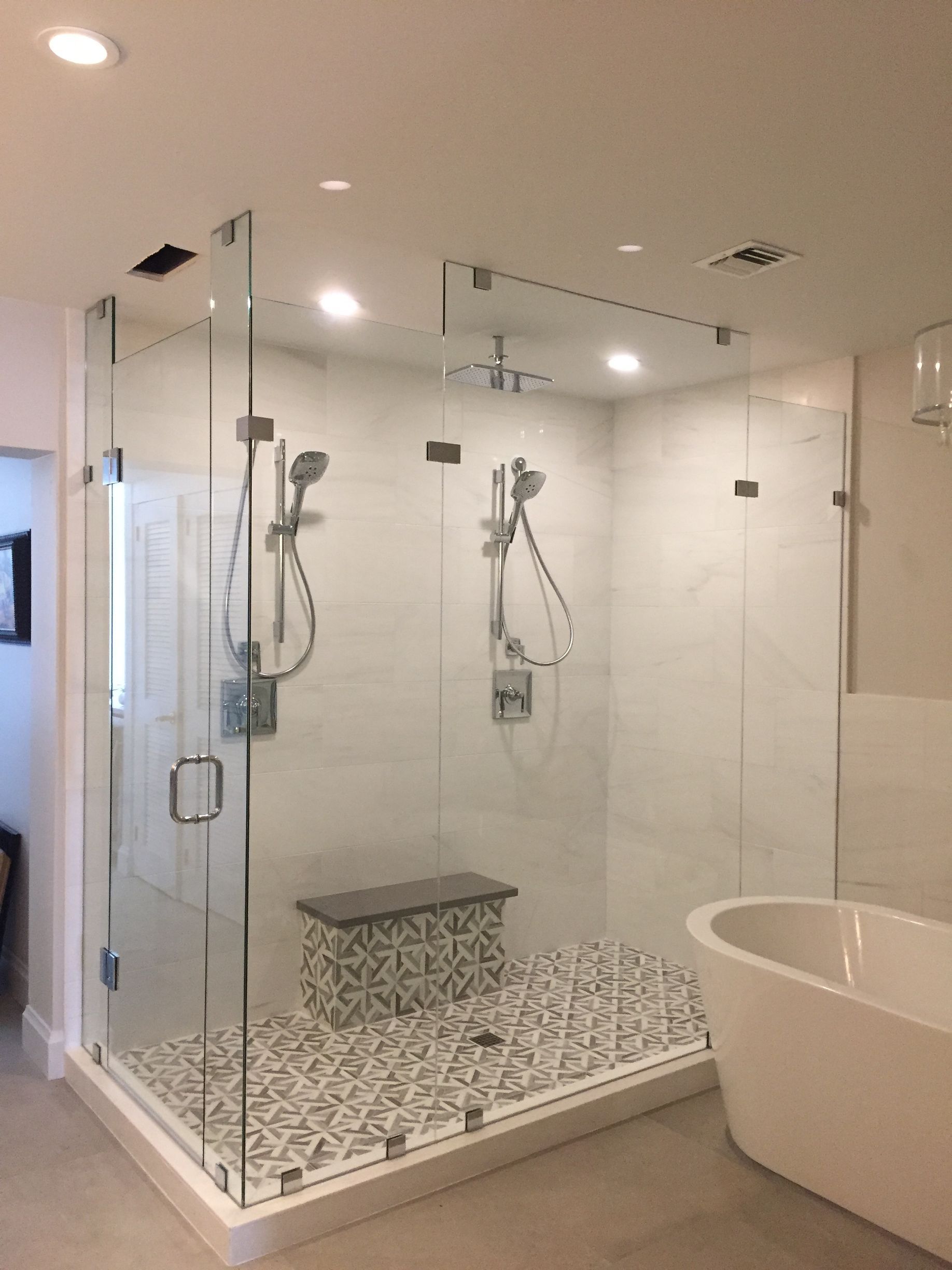 A bathroom with a walk in shower and a bathtub