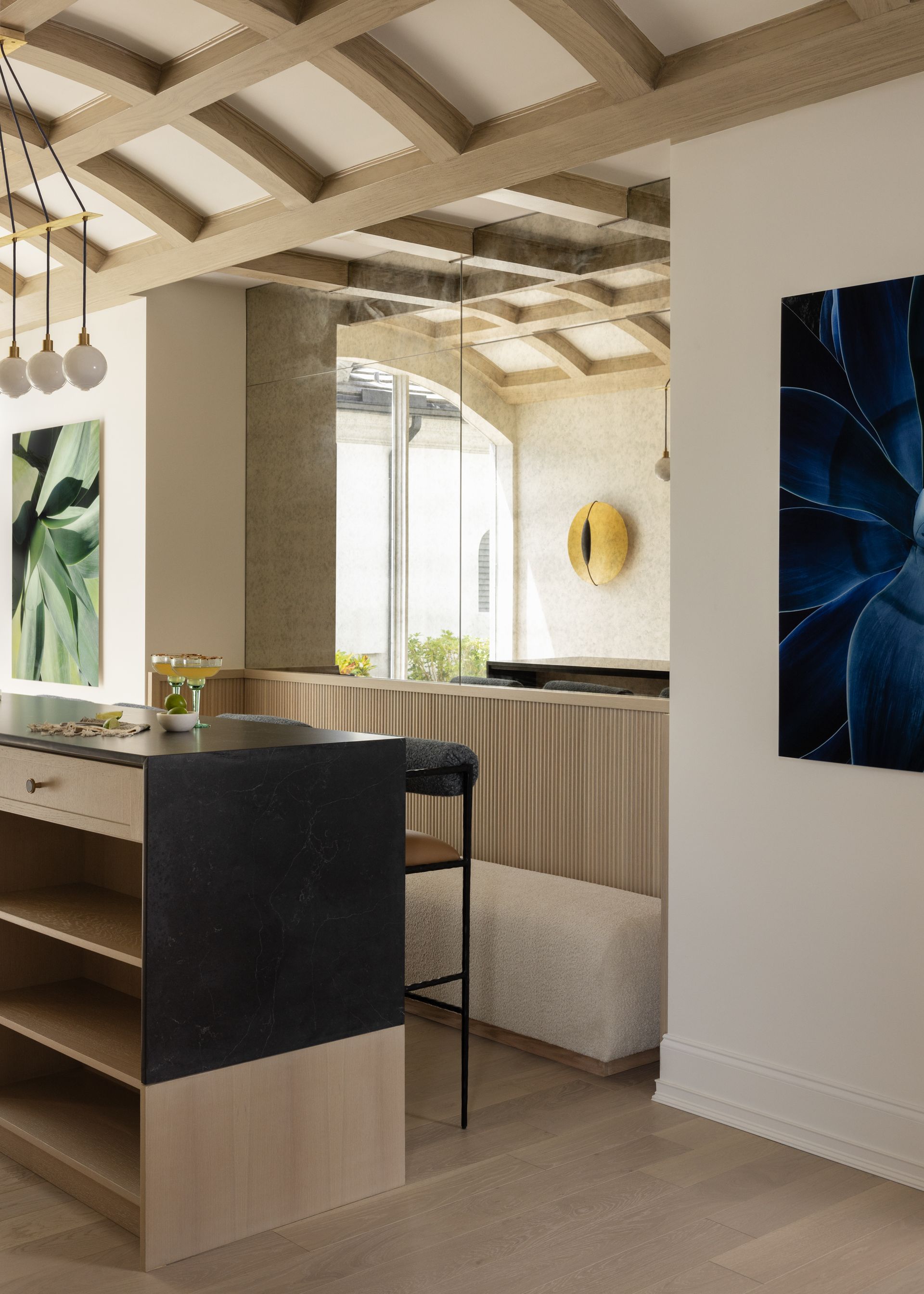 A kitchen with a large island and a painting on the wall