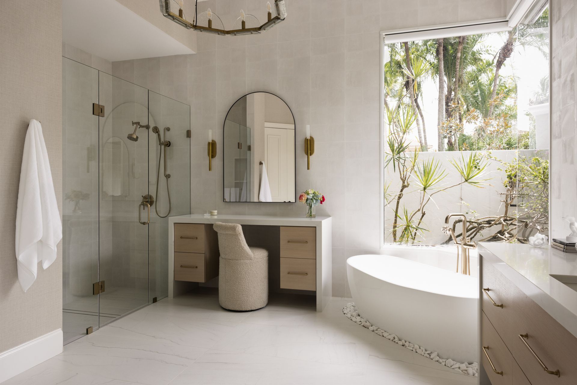 A bathroom with a tub, sink, mirror and walk in shower.