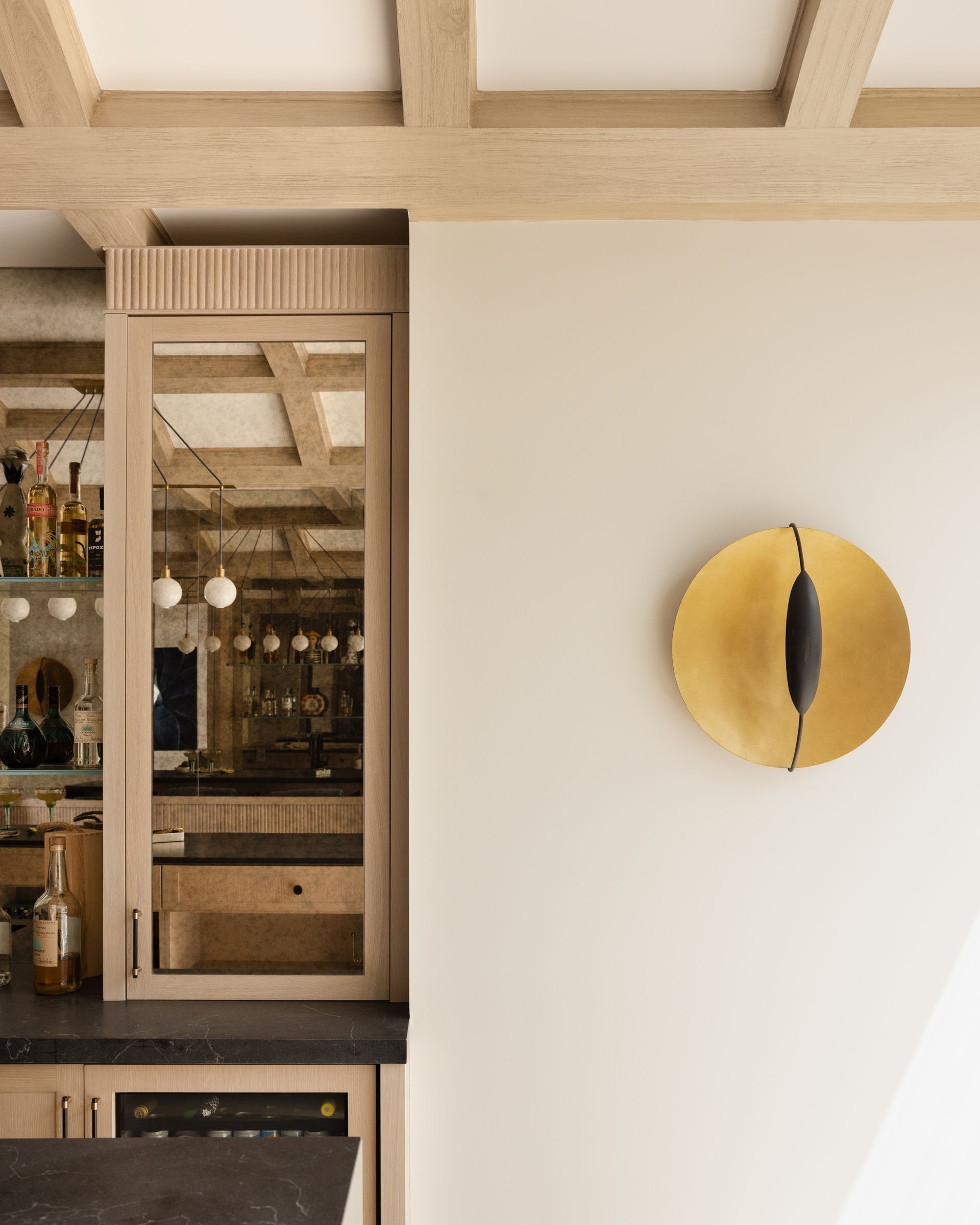 A kitchen with wooden cabinets and a gold plate on the wall.