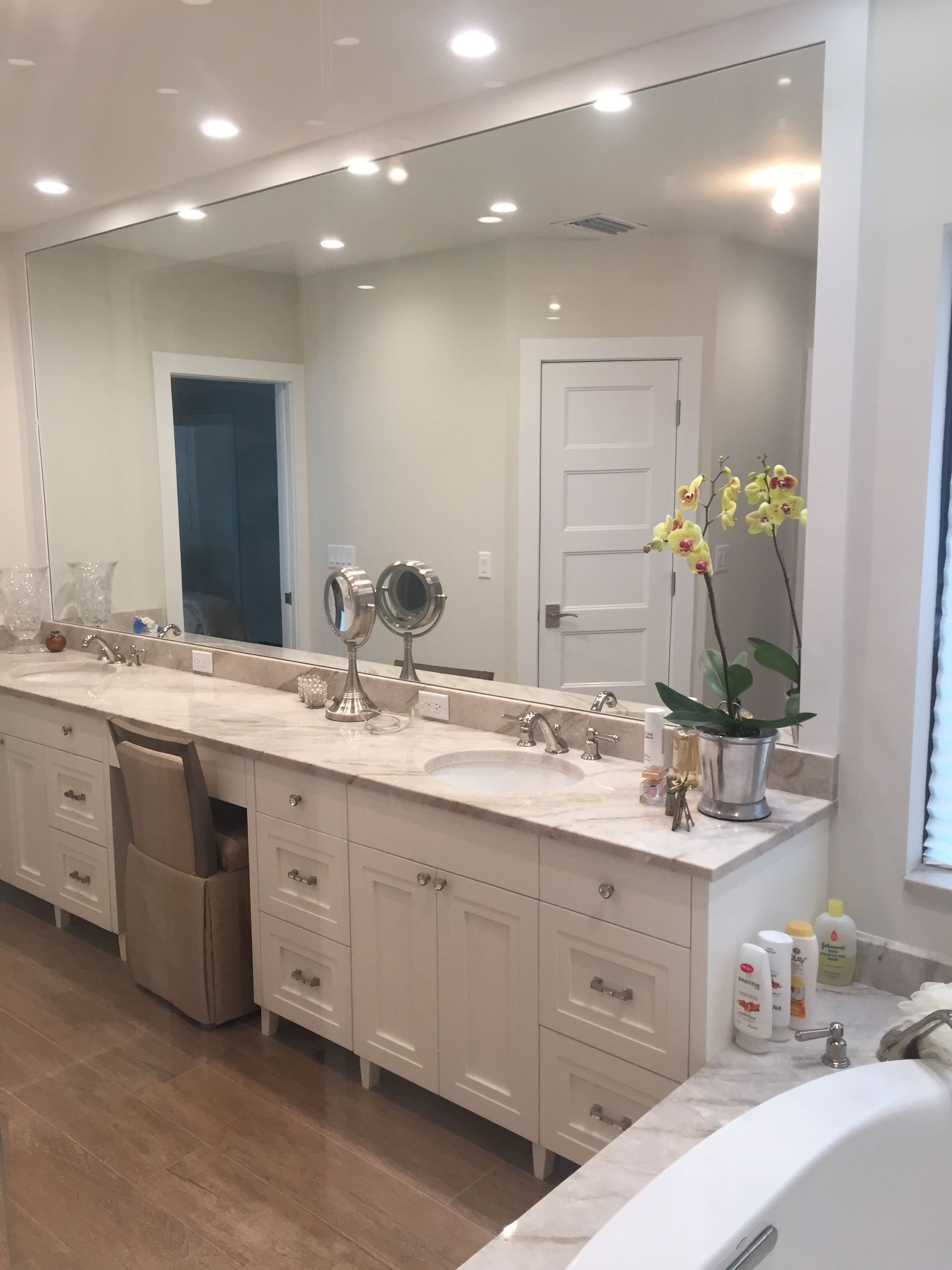 A bathroom with two sinks and a large mirror.