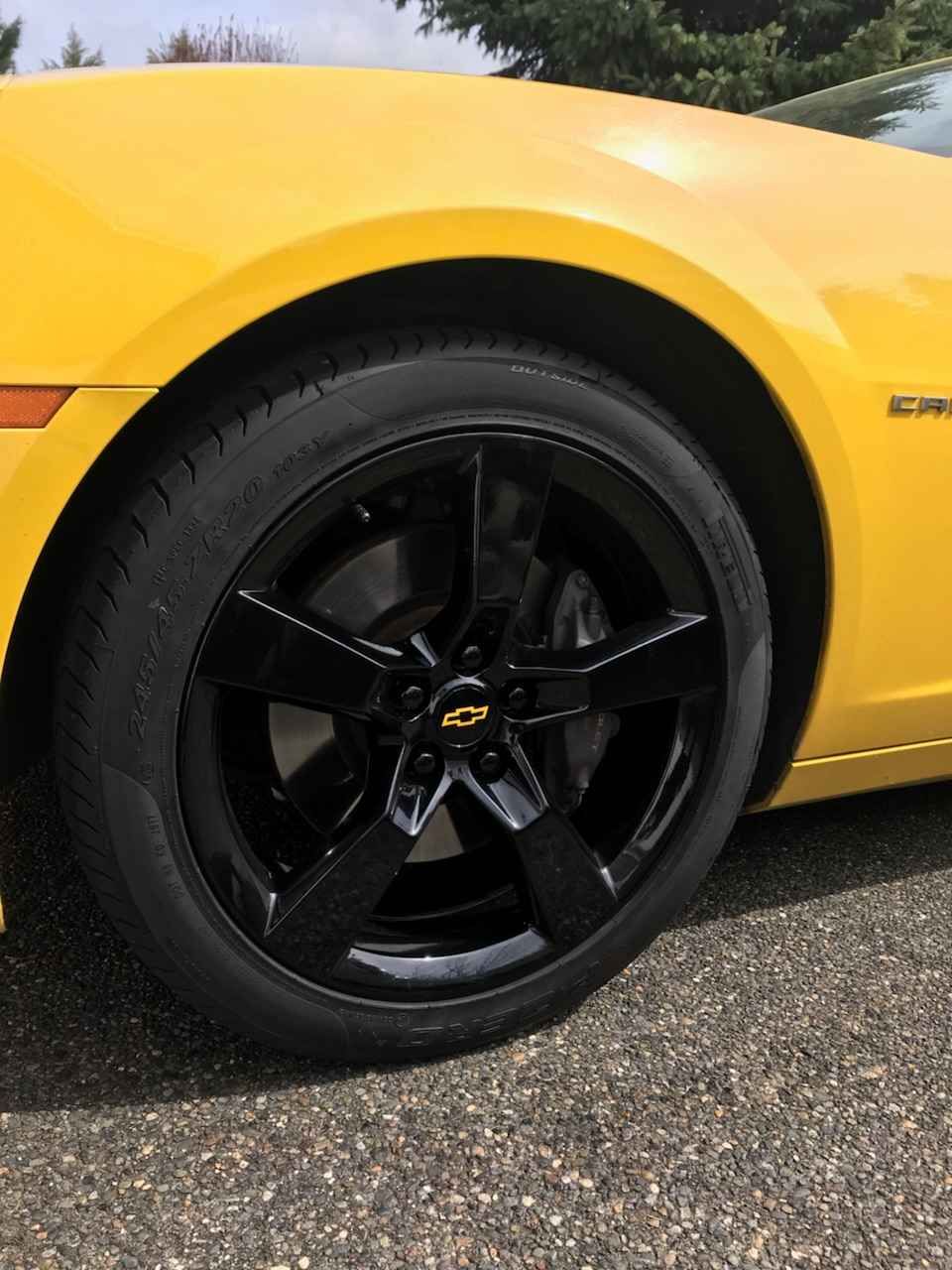 Yellow Chevrolet Camaro with black rims.