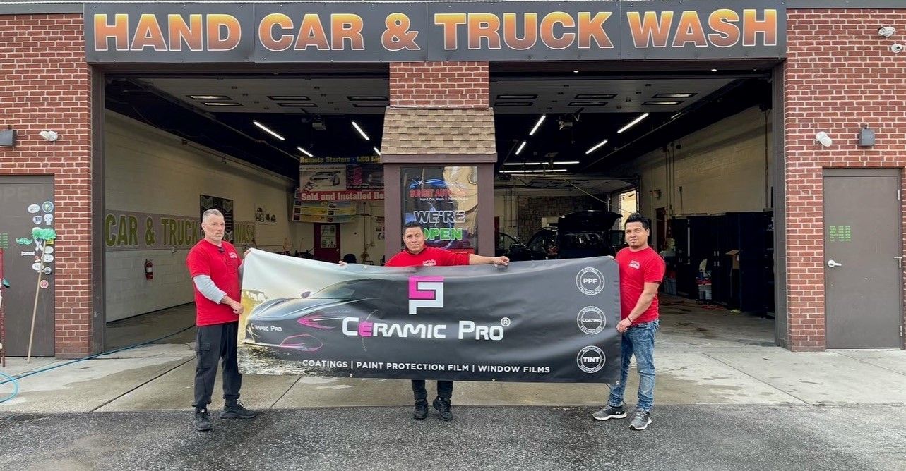 Three guys holding a Ceramic Pro sign