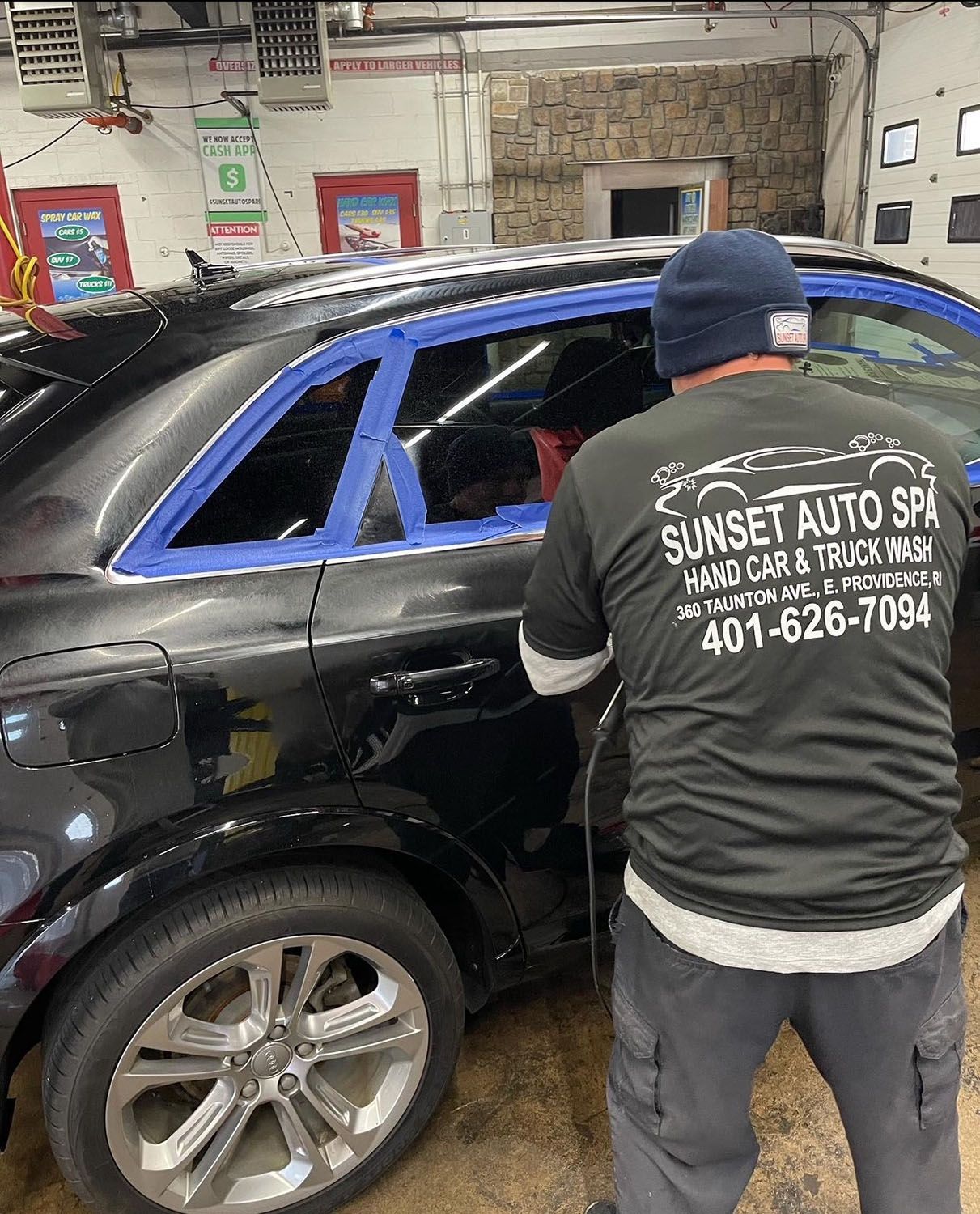 Man cleaning the doors of a car