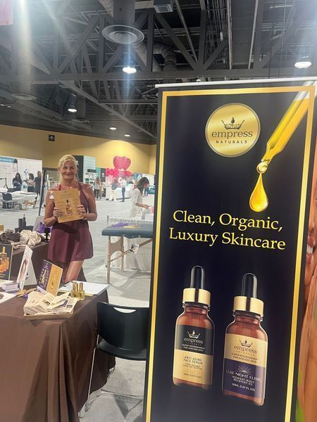 Woman at a skincare booth; a banner reads 