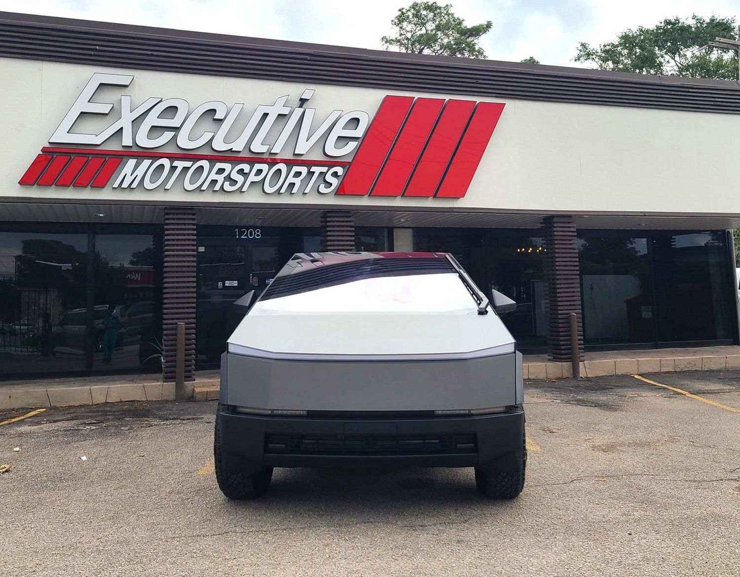 An electric car is parked in front of the shop