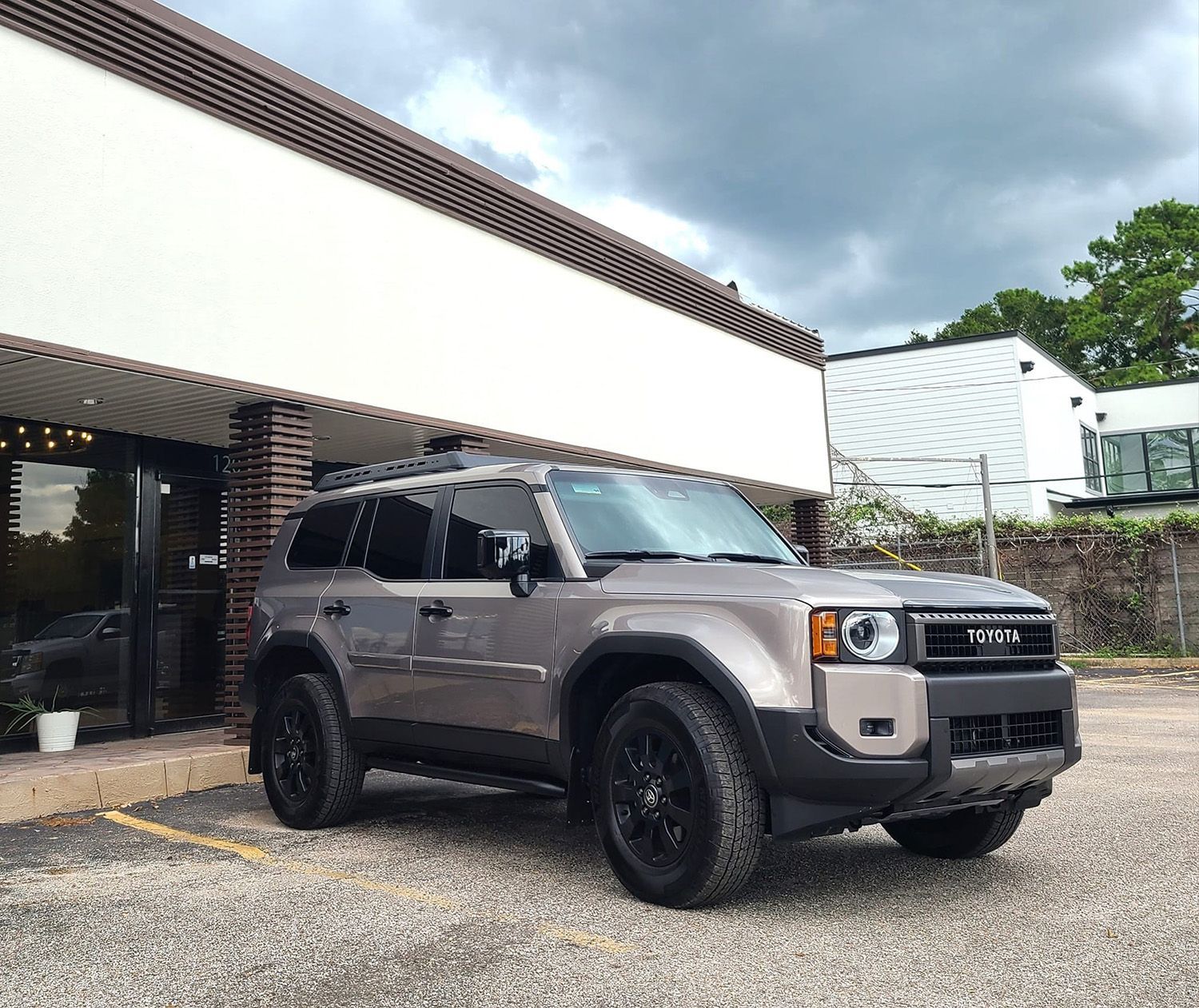 A toyota suv is parked in front of a building