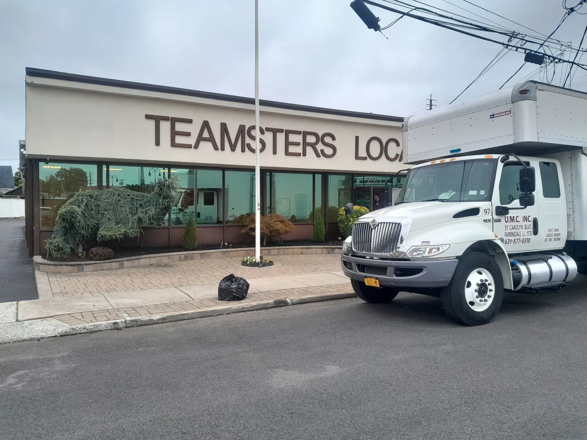 Teamsters Local building with a white work truck parked outside.