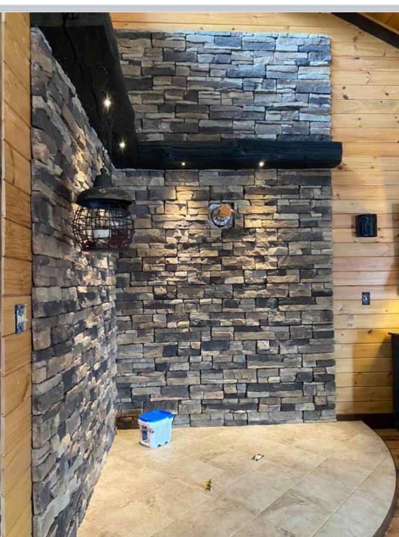 A room with a brick wall and a wooden ceiling.