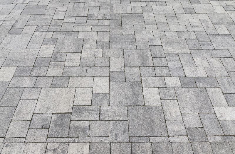 A close up of a brick floor with a geometric pattern