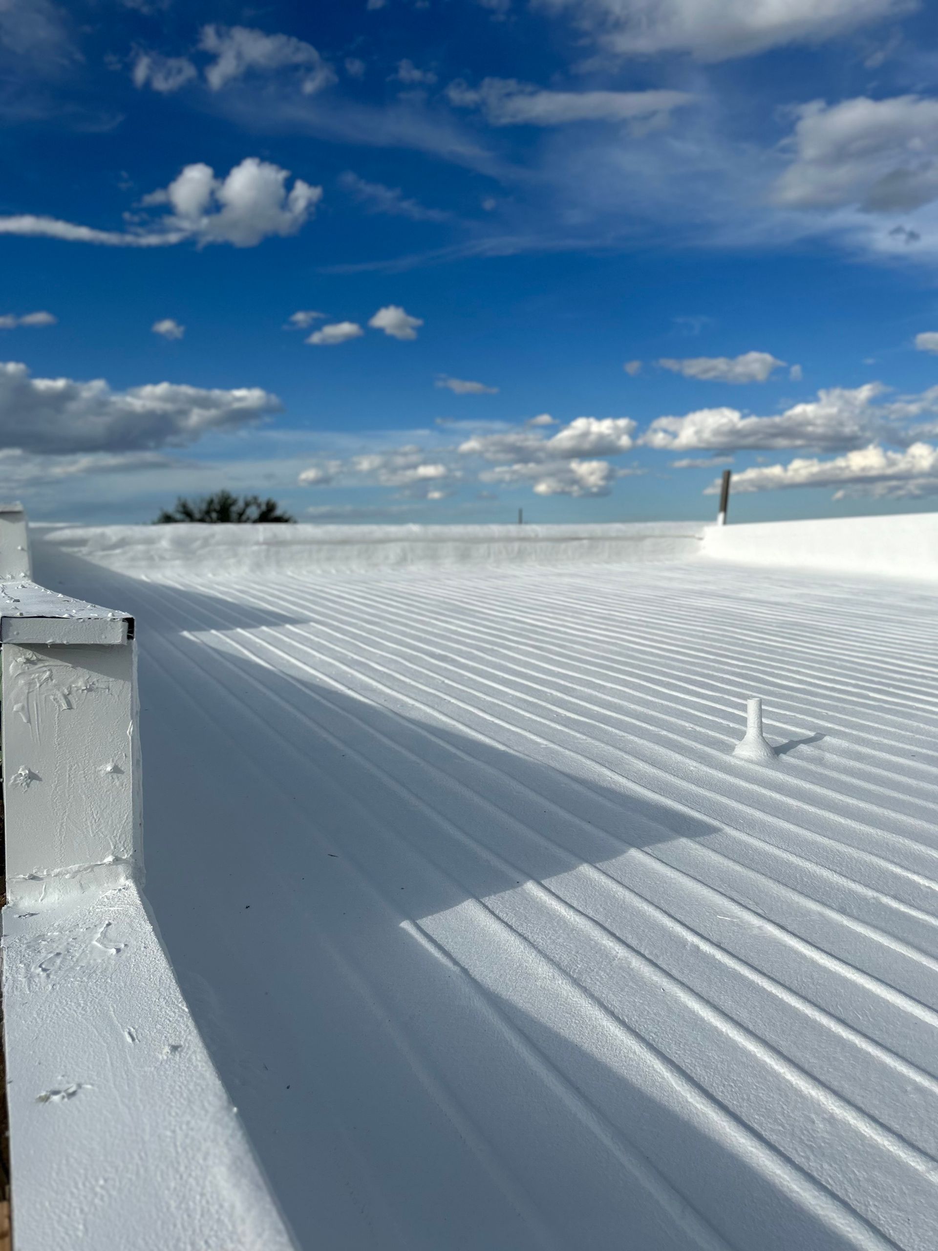 A white roof with a blue sky in the background