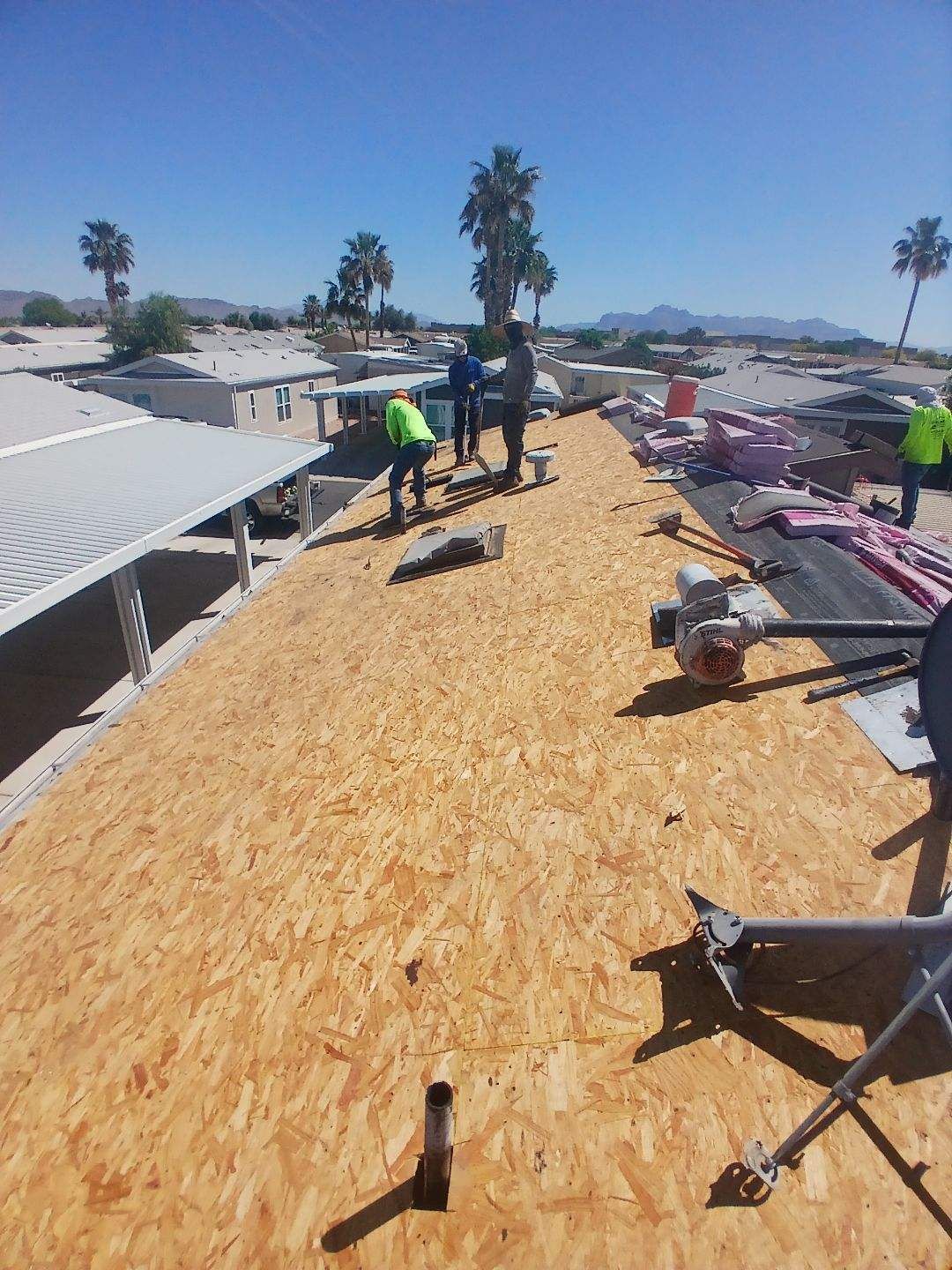 A group of people are working on the roof of a building.