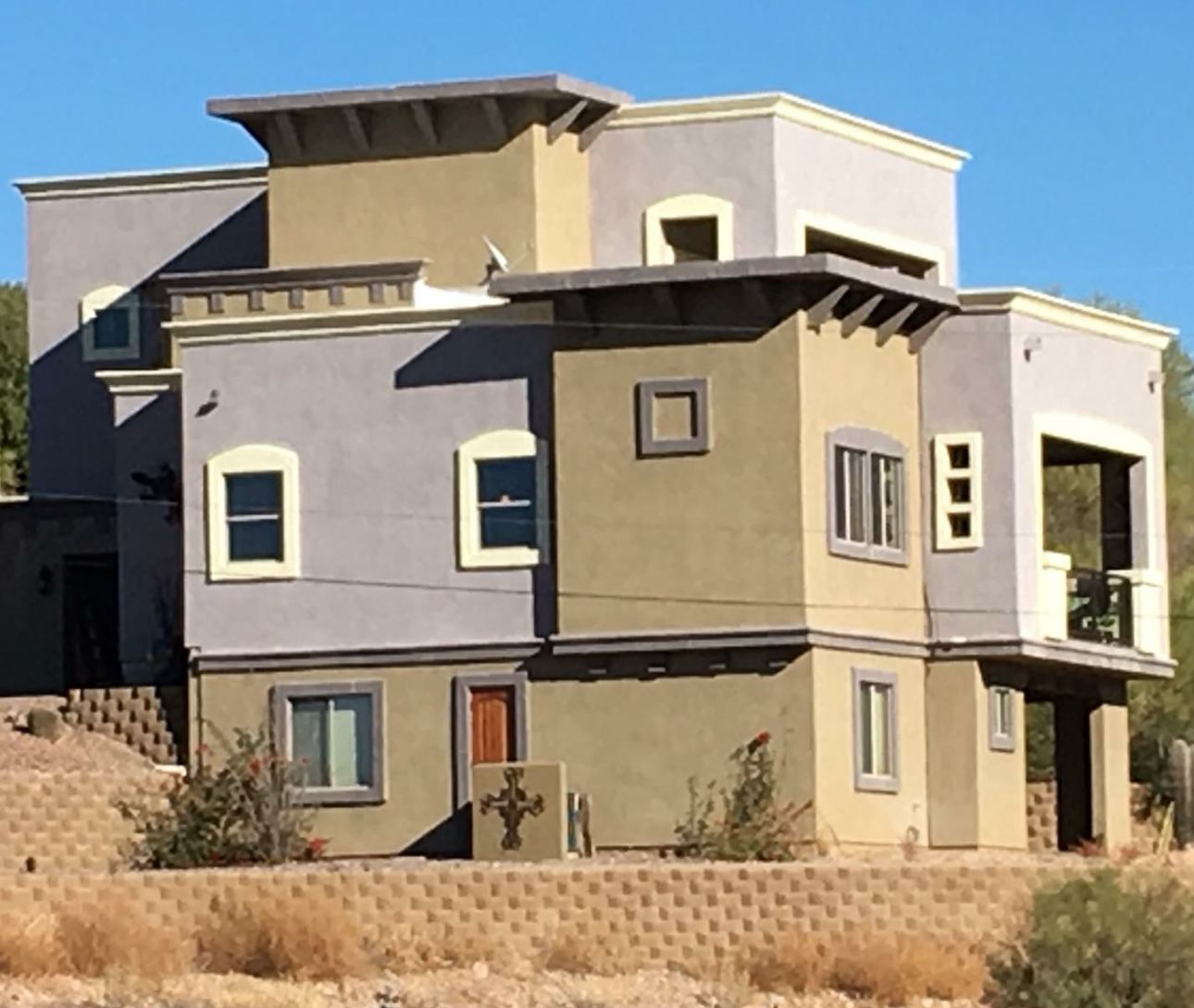 A large house with a cross on the side of it